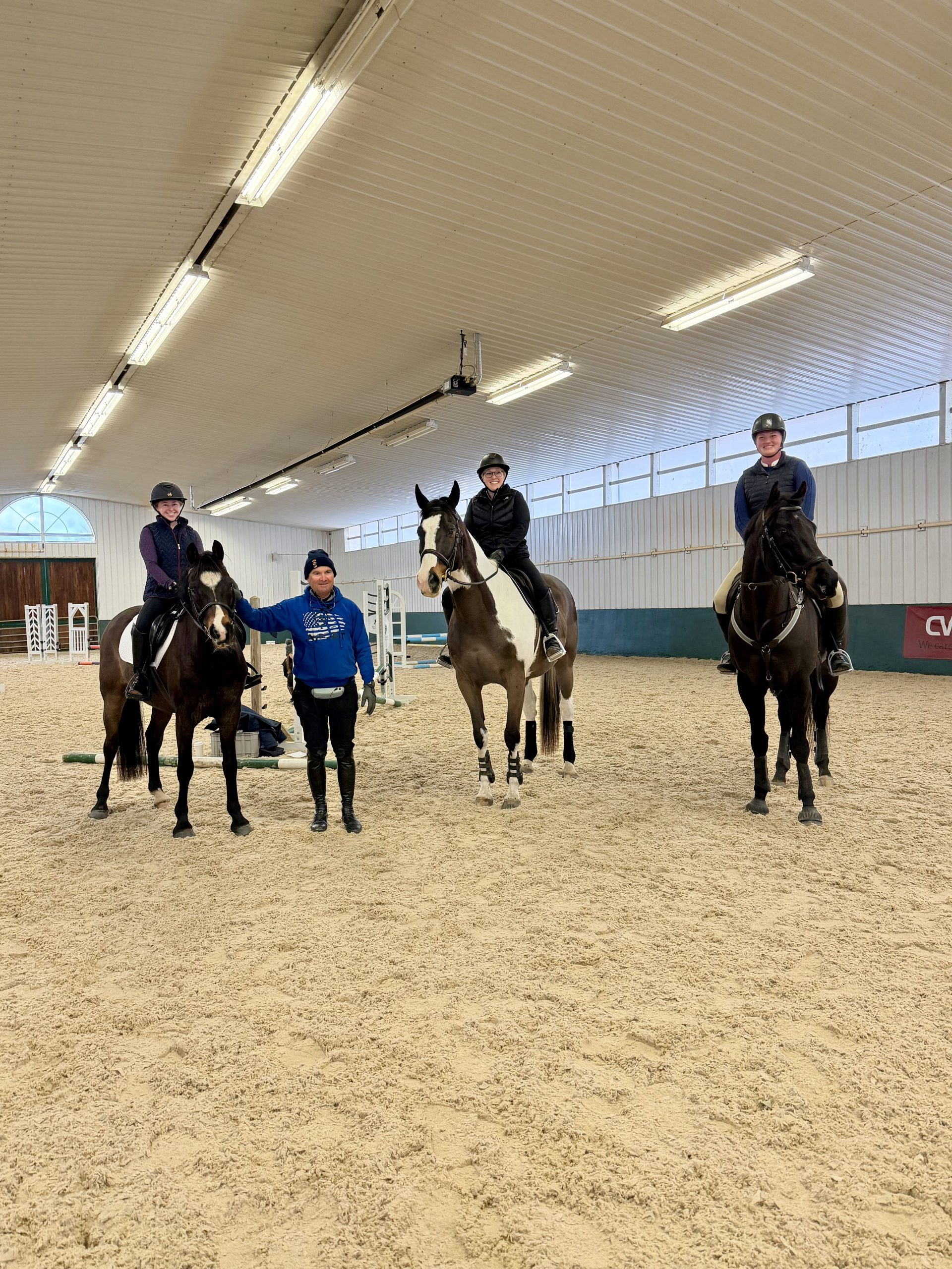 Riders participating in a Phillip Dutton jumping clinic at Renaissance Equestrian Center indoor arena, March 2026